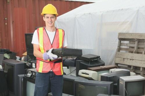 Workers sorting office recyclables into separate categories